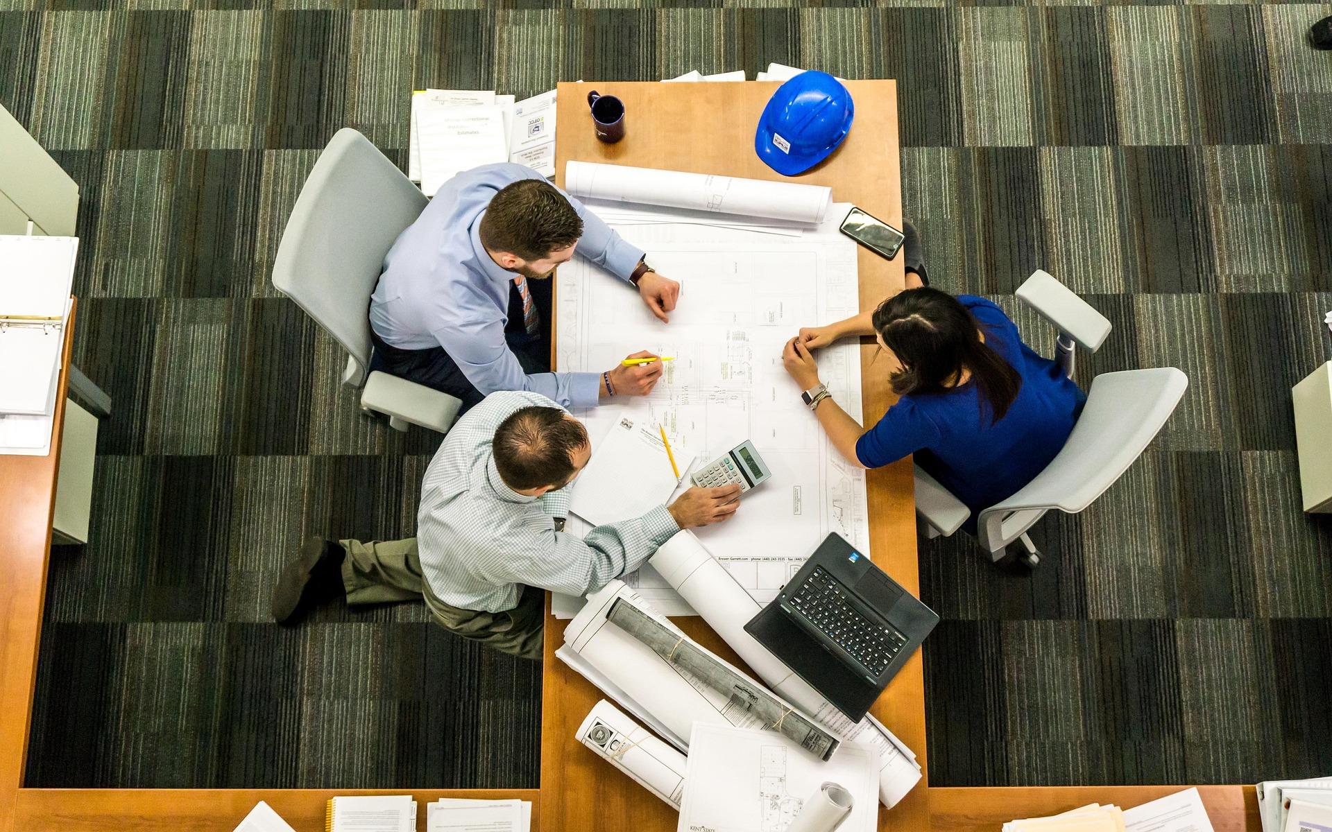 A team reviewing development plans and survey documents